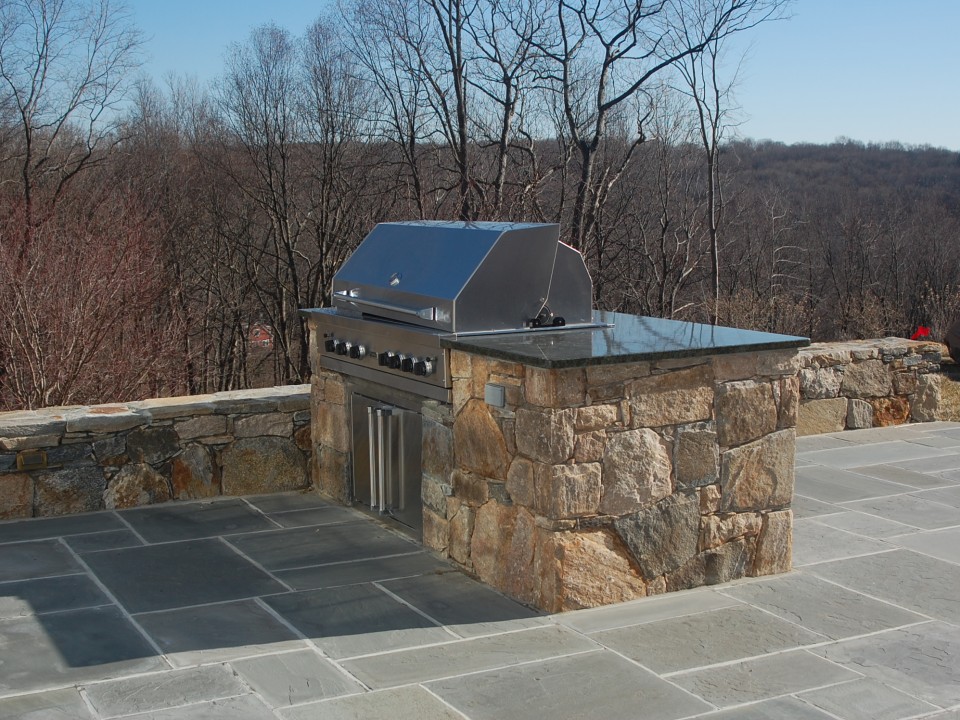 Fieldstone wall, granite countertops, built-in cooktop