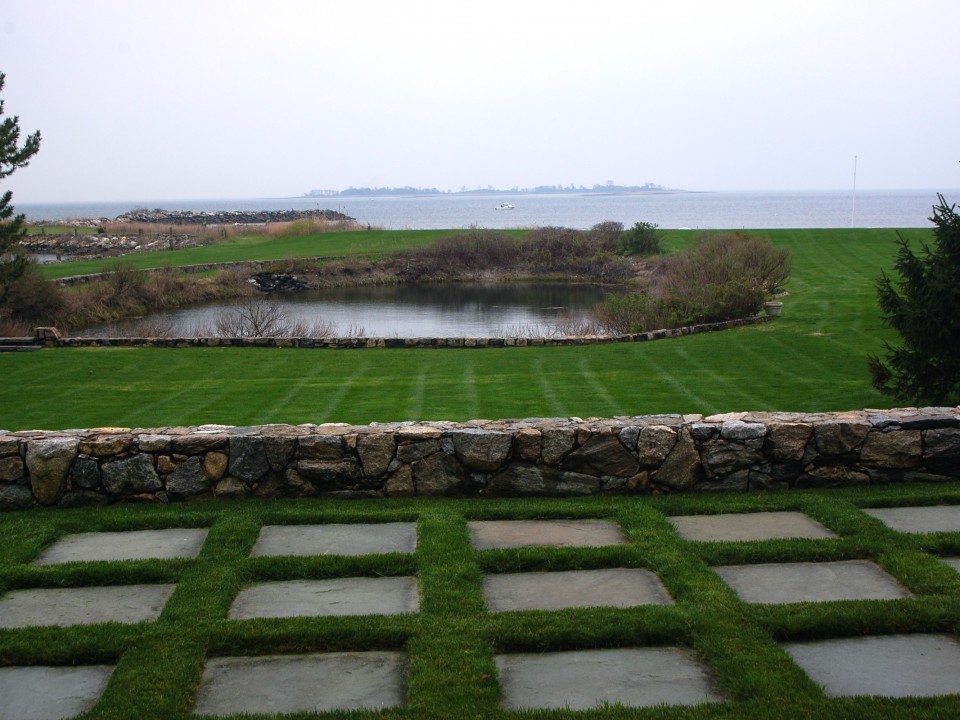 Bluestone and sod with fieldstone retaining wall