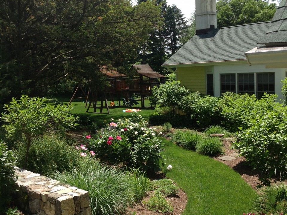 Fieldstone Wall and Grass Path Through Garden