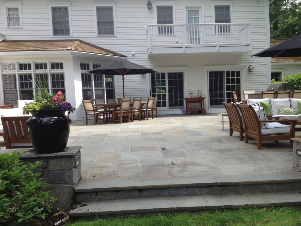 Bluestone patio with sitting walls and outdoor kitchen