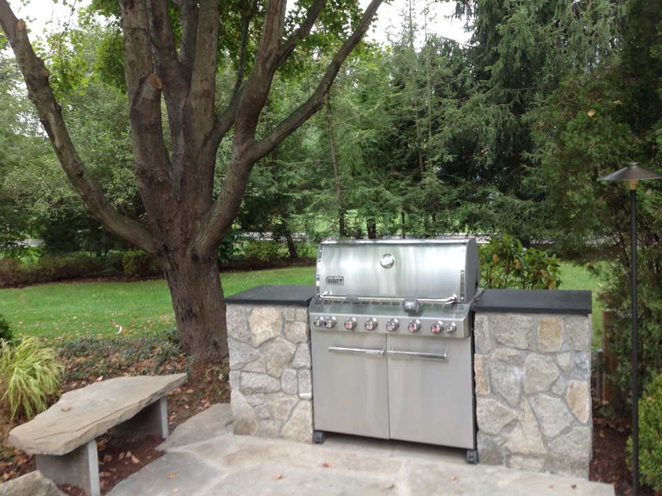 Grill niche using existing grill with granite countertops and fieldstone walls